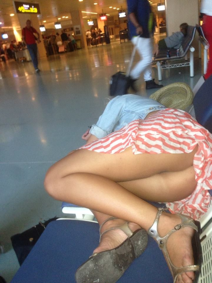 Candid upskirt of a lady at the airport not wearing panties