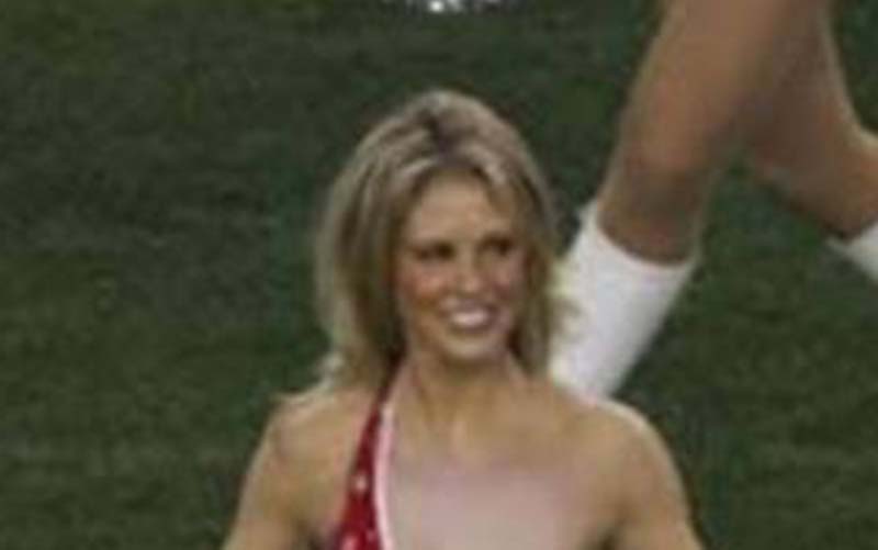Cheerleader wardrobe malfunction photographed at a football game.
