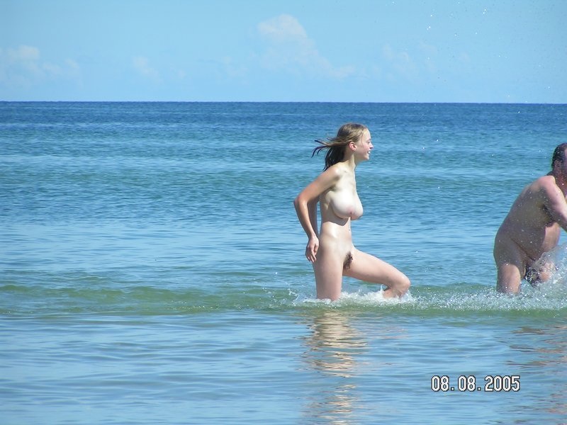 Busty teen nudist candid pictures at the beach taking a dip