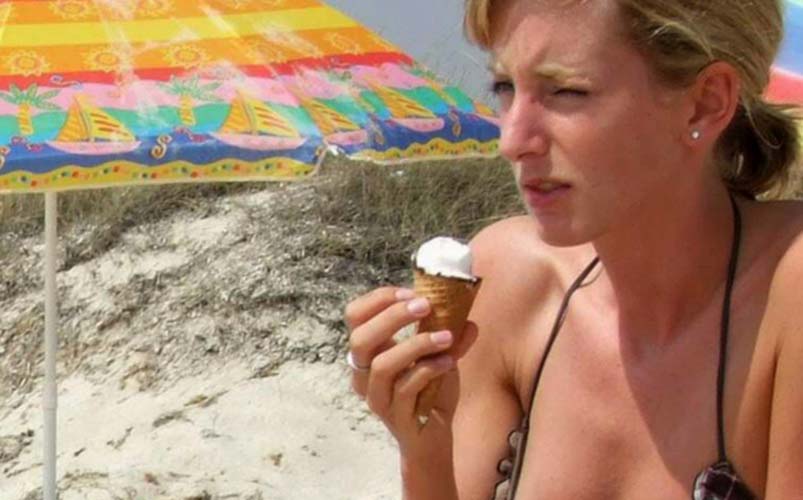 A beach nipple slip is seen while she has her ice cream - Voyeur Hub